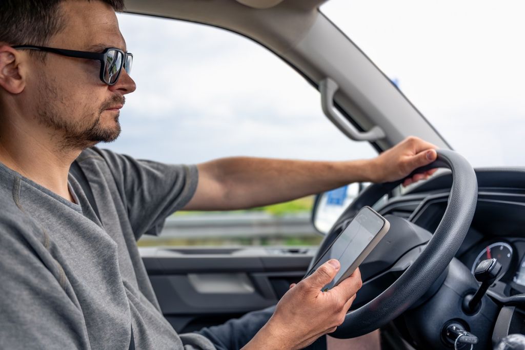 driver-holding-phone-smartphone-hand-car-motion.jpg